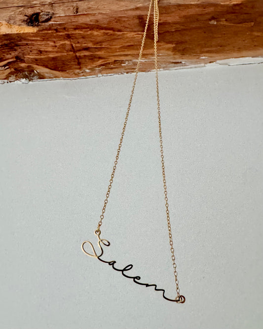 Baubles Baubles – Script Salem Necklace (Gold) - Witch by Weekend 